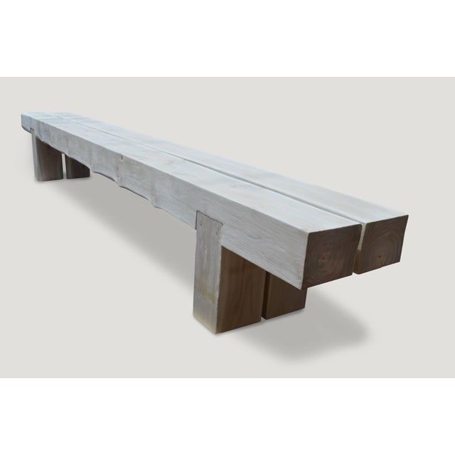Impressive reclaimed bleached teak wood log bench. Perfect for inside or outside living. The two top pieces rest on a...