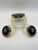 Elegant vintage vanity jar trio featuring ribbed clear glass bodies with deep cobalt blue lids, gold-tone trim, and...