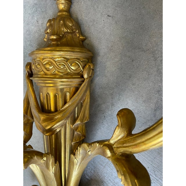 Large pair of late 19th century Louis XV style gilt metal 3 light wall sconces with urn finials. H 25”