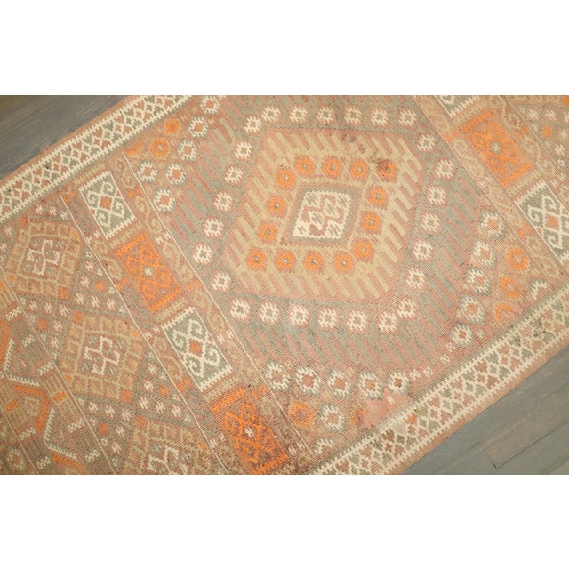 A Mid-Century Turkish Kilim flat-weave in predominant cream and orange tones. 3' x 13'4''
