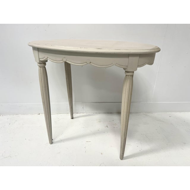 Oval Art Deco side table in patinated beechwood Four tapered legs with recessed fluting Scalloped apron Good condition...