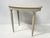 Oval Art Deco side table in patinated beechwood Four tapered legs with recessed fluting Scalloped apron Good condition...