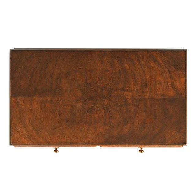 A molded rectangular top rests over five individual drawers over a bracket base. Care Instructions: Our wood stain and...