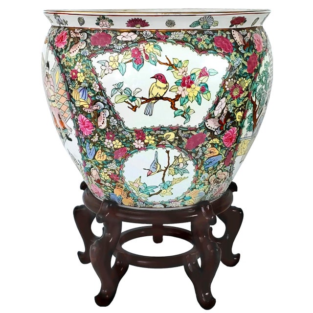 Offering a large hand-painted Rose Medallion Chinese porcelain ceramic goldfish planter on a wood stand, circa Early to...