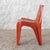 Orange fiberglass-reinforced polyester resin chair. It is the first plastic chair in history manufactured in a single...