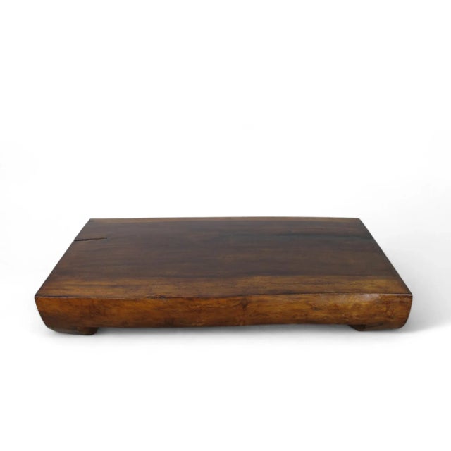 This handsome coffee table is hand carved out one single slab of wood. Gorgeous wood grain and natural edge. 4" thick top...