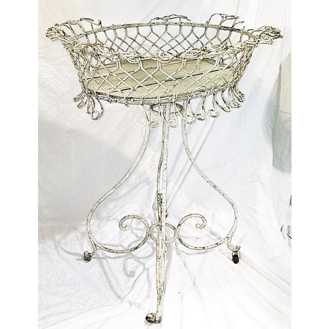 A special piece, this 19c French metal twisted wire planter on rolling stand that's been in the family since we imported...