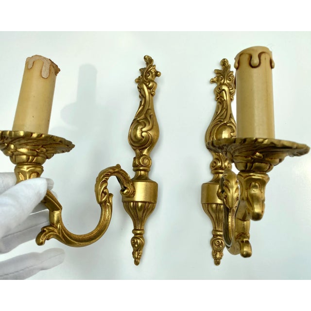 Pair of vintage French wall sconces, a testament to mid-century craftsmanship. Dating back to the 1960s, these sconces...