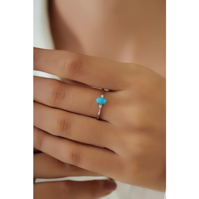 This three stone ring features a 0.56 carat oval turquoise set in 14K white gold. The turquoise measuring approximately...