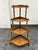 Design Plus Gallery presents a 1920's Tiered Corner Display Shelf/Plant Stand of Oak Wood. This vintage oak piece has a...