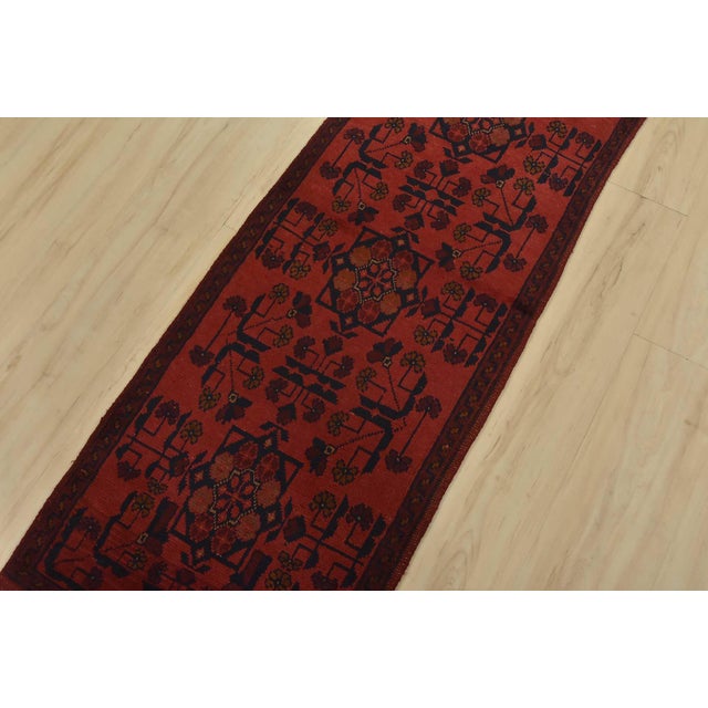 An authentic tribal Turkmen runner hand-knotted with an all-wool pile on a cotton foundation. This oriental rug features a...