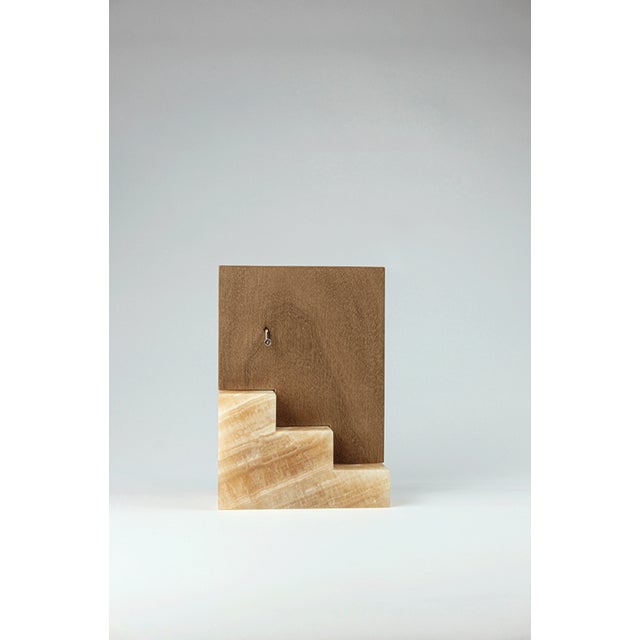 Music box in honey onyx and walnut wood transform the archetypal signs of dwelling into sound and material presence. The...