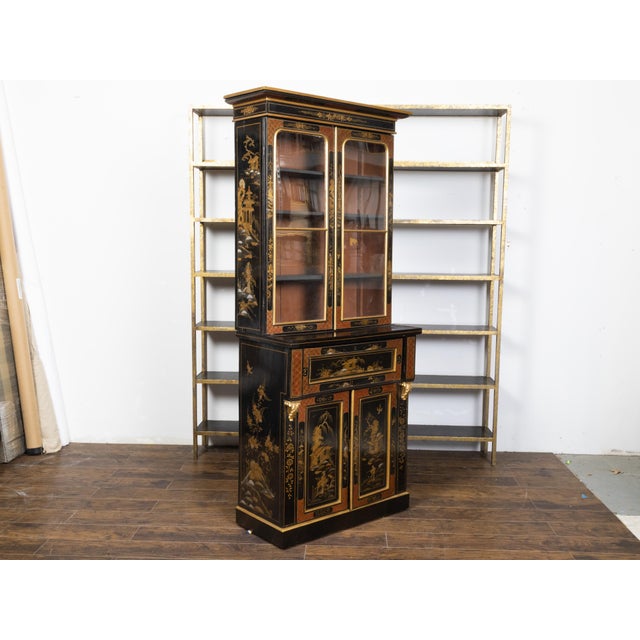 An English black lacquer secretary bookcase from the 19th century, with glass doors, drop-front desk and gold Chinoiserie...