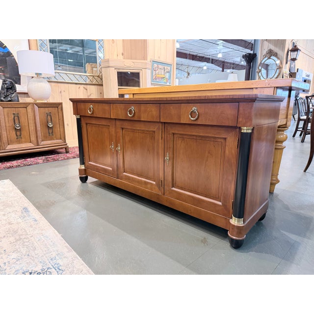A distinguished sideboard by Baker Furniture from the Palladian Collection, executed in rich walnut with refined...