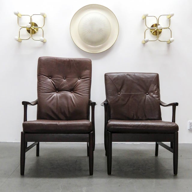 Wonderful set of two Danish leather arm chairs by Ole Wanscher, matching high and low back versions, solid dark beech...