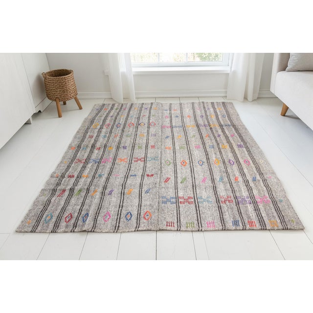 This is a vintage Turkish Oushak rug from the Mid 20th Century. The piece was hand-knotted.