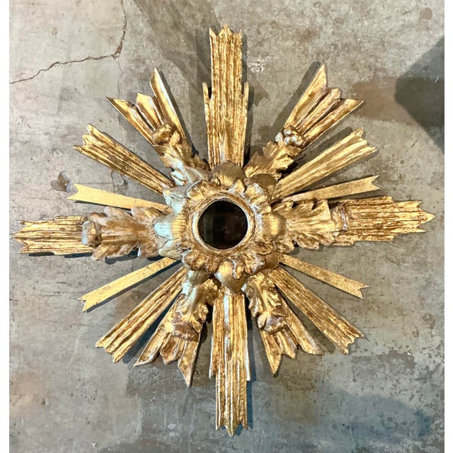 Elevate your walls with the celestial drama of this vintage gilt wood sunburst mirror. Modeled after the "glory" or auras...
