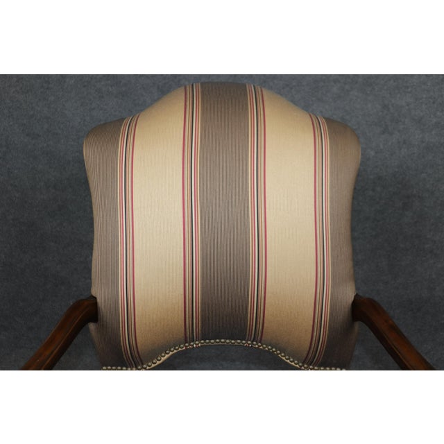 Discover timeless elegance with this exquisite pair of French Louis XV walnut armchairs, showcasing masterful 18th-century...