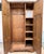 Dating to the early-to-mid 20th century, this handsome English oak wardrobe by Crown AY Furniture showcases the rich...