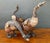This charming set of three vintage carved wood goose sculptures captures the warmth and authenticity of rustic folk art....