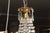 A beautiful example of a French Empire crystal basket chandelier showcasing a finely detailed gilt bronze frame and an...