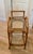 Mid Century rolling cart with a curved rattan frame and 2 glass shelves. In excellent condition.