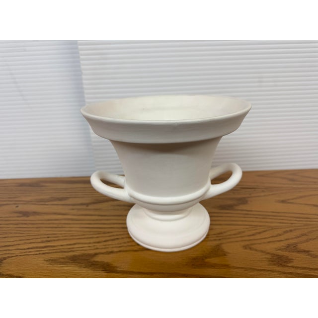 Design Plus Gallery presents a Trophy Urn or Pedestal Vase with Double Handles. Made from white ceramic, this multifaceted...