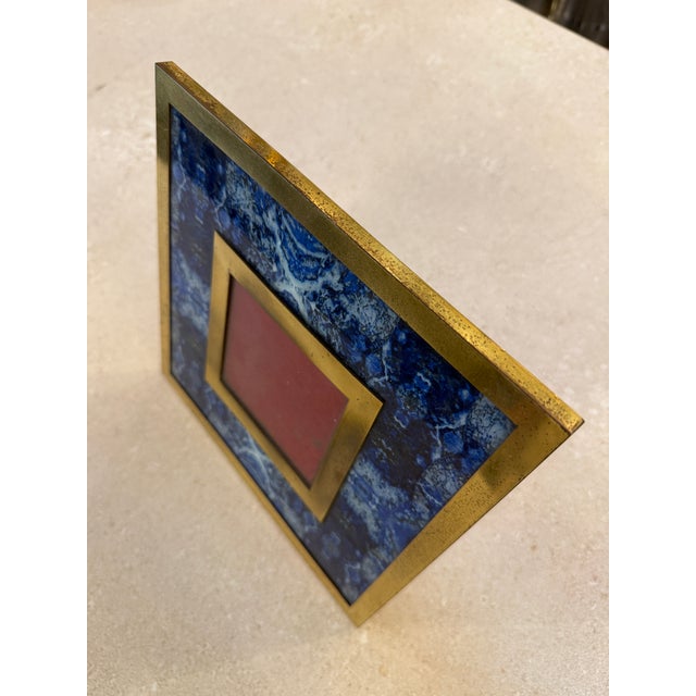 Elegant Italian mid-century picture frame featuring a rich brass structure paired with a striking blue lapis-style stone...