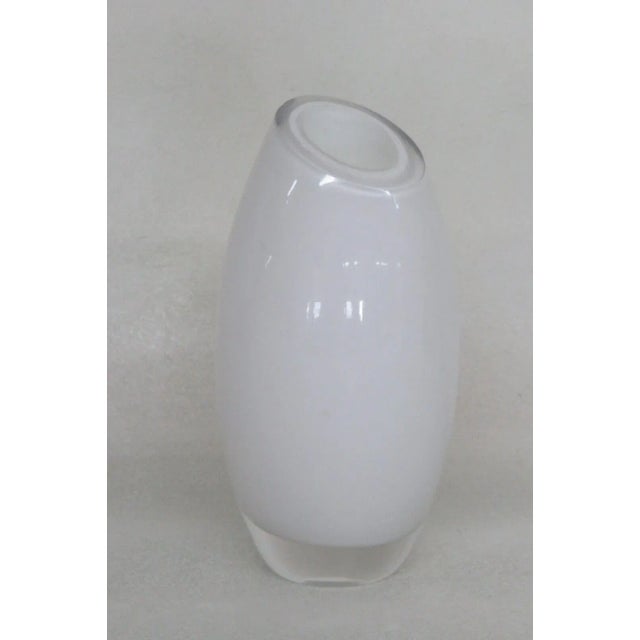 This wonderful small vase is made of cased glass. This lovely vase was made with a beautiful white interior layer and...