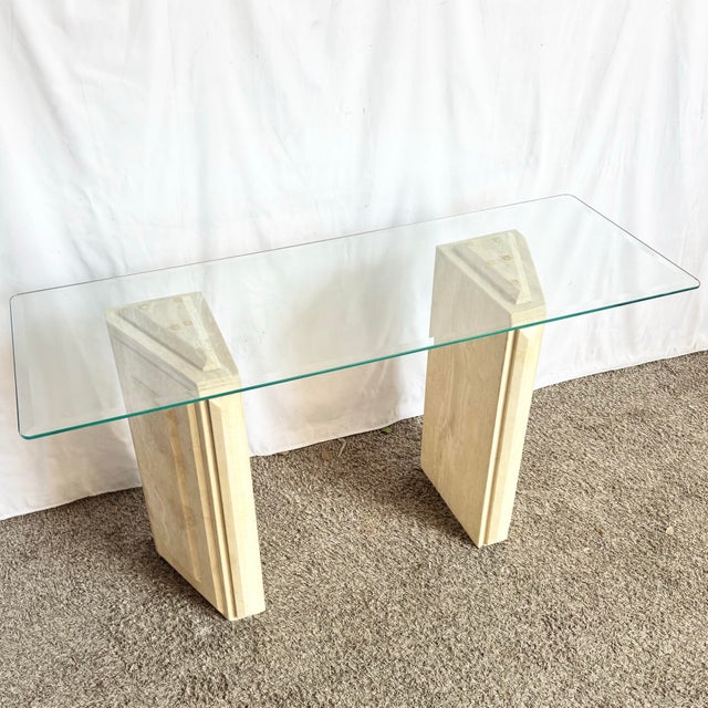 A refined blend of natural elegance and sculptural form, this vintage console table features a sleek glass top resting...