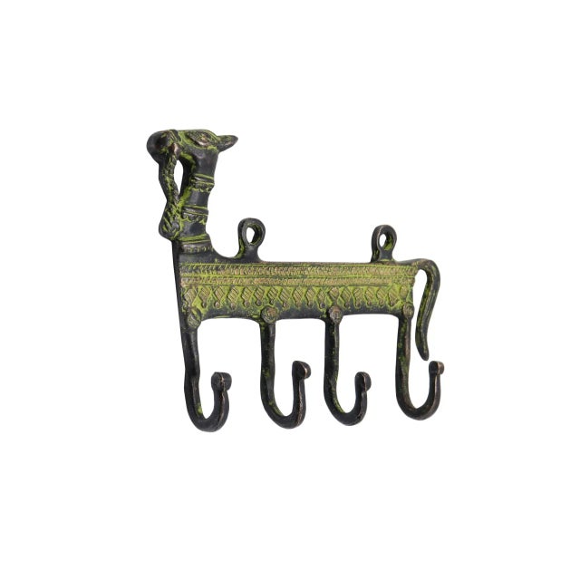 A bohemian green brass wall fixture with four hooks. A central bar is cast with a camel head and tail and is decorated...