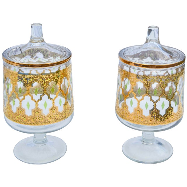 Gorgeous set of two midcentury handblown 22-karat gold Culver glass candy jars, exhibiting an elaborate hand-painted...