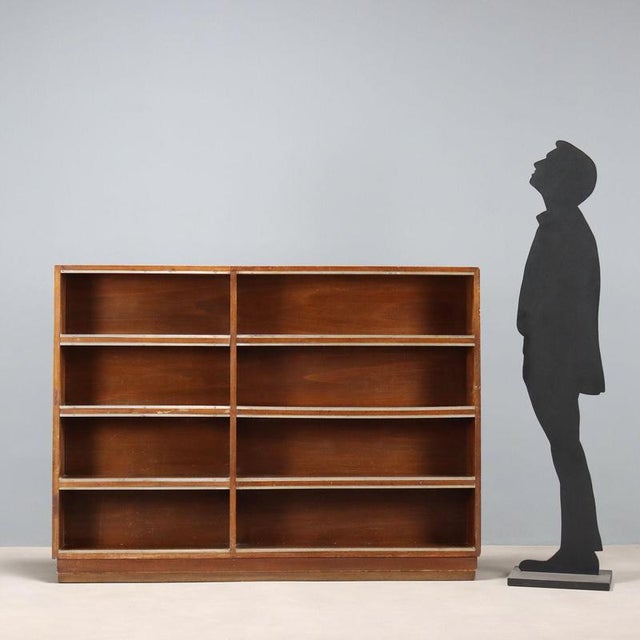Open walnut bookcase with flush metal trim. Italy, second quarter of the 20th century. This piece is attributed to the...