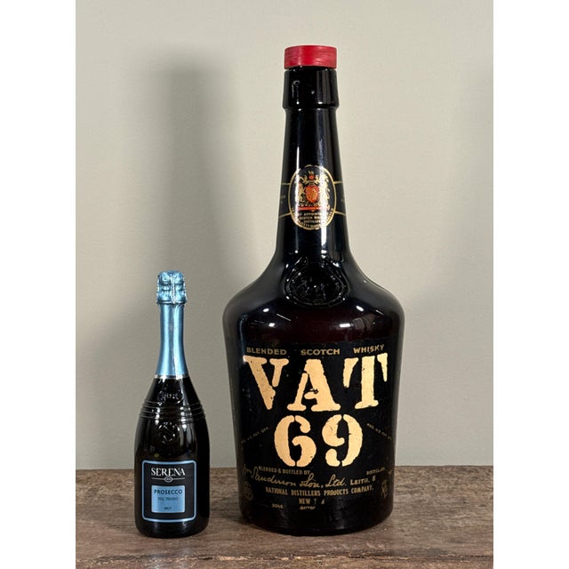 This vintage oversized display bottle for VAT 69 Blended Scotch Whisky was produced for store or bar advertising. The dark...