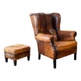 1970s Vintage Art Deco Distressed Cognac Leather Wingback Chair & Ottoman For Sale
