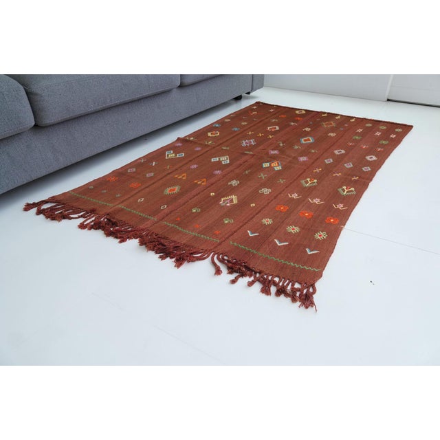 This is a vintage Turkish Oushak rug from the Mid 20th Century. The piece was hand-knotted.