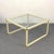 Midcentury coffee table in a delightful cream-colored enameled metal, with brass corner pieces. The attribution to Tommaso...