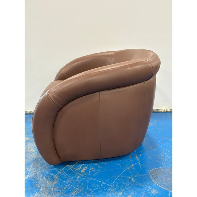 Stylish Modern Brown Leather Swivel Chair. Curved body. Showroom floor sample.