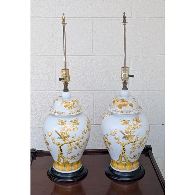 These exquisite Chinoiserie ginger jar lamps are a masterclass in hand-painted elegance. Crafted from fine white...
