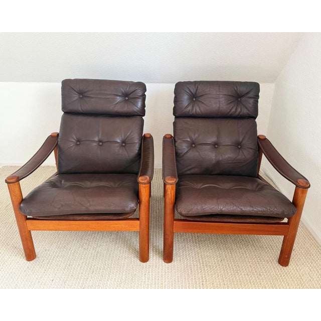 A pair of elegant Danish lounge chairs designed by Ebbe Gehl & Søren Nissen in the 1970s. These chairs feature solid...