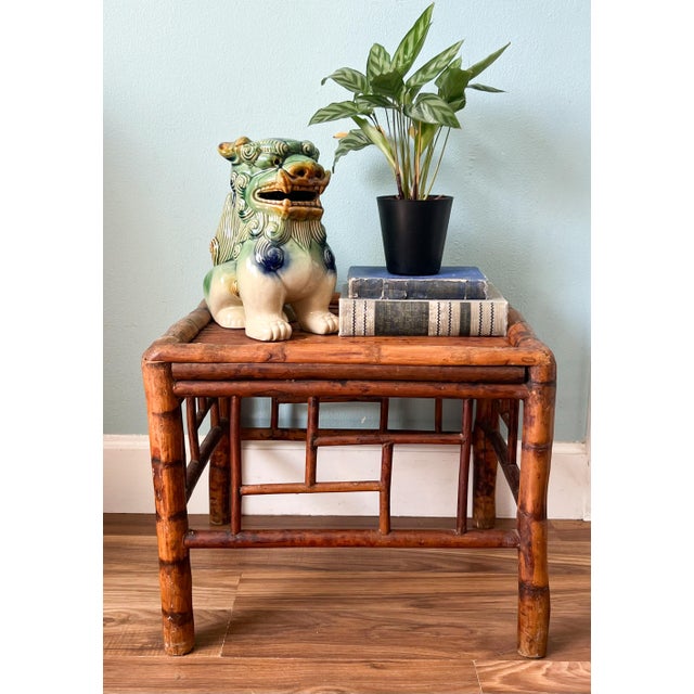 Handcrafted early to mid 20th-century Asian bamboo side table featuring a warm, beautifully aged finish and geometric...