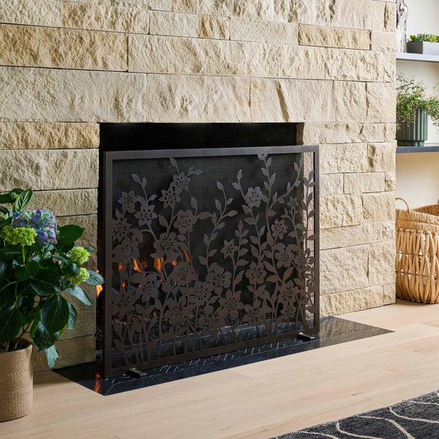 A romantic tangle of hand-cut metal blooms creates a soft yet structured composition, where delicate petals and graceful...