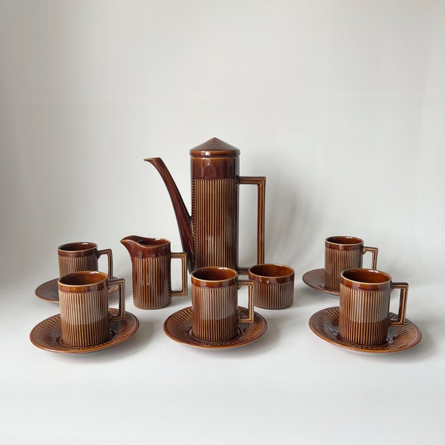 Bring a touch of classic mid-century warmth to your display with this vintage ceramic coffee set. Showcasing a rich,...