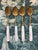 Elegant Victorian-era dessert or tea spoons featuring hand-carved mother-of-pearl handles, neoclassical ferrules and gilt...