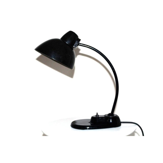 This table lamp features a Bakelite shade, a metal base, and is smoothly adjustable via joints. European Plug (up to...