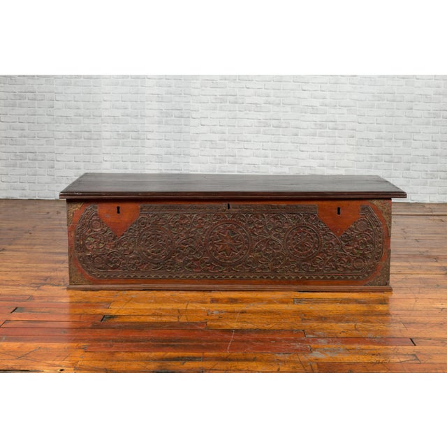 An Indonesian late 19th century coffer from Sumatra with carved geometric motifs, scrolling patterns and original finish....