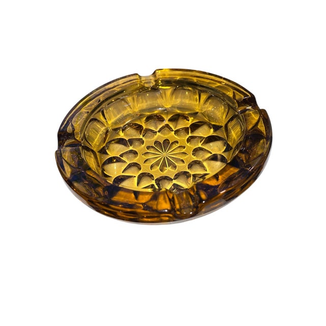 Unique Vintage Mid-Century Modern era amber ashtray or Catchall. Graduating 12 point star or flower pattern on raised...