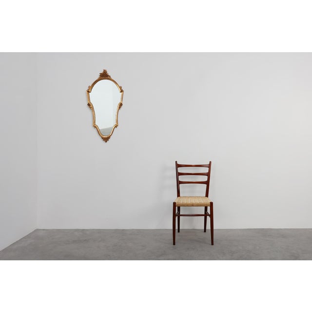 This elegant French mirror from the 1950s captures the enduring grace of the Louis XVI style. Its elongated shield‑shaped...