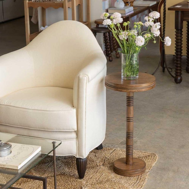 Solid dark oak circular drink table with carved ribbed detailing; inspired by French design. Designed in Los Angeles....