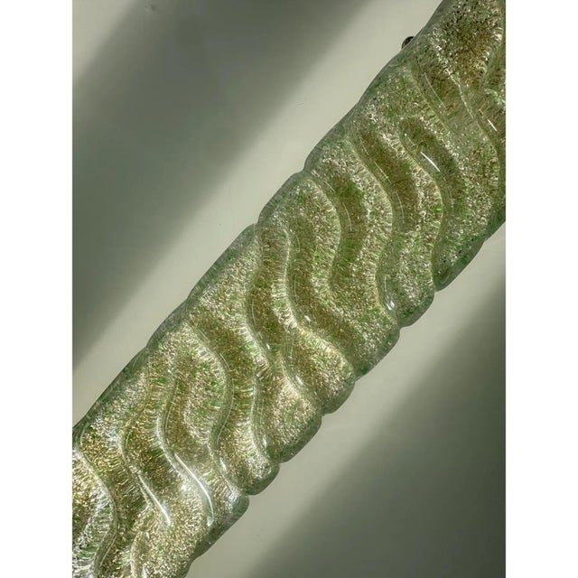 Contemporary rectangular wall sconces made in clear and green “graniglia” murano glass – set of two the metal frame in a...